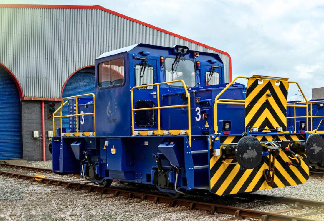 Modern blue industrial locomotive equipped with advanced safety features and electric controls, representing next-generation haulage technology innovations in 2025.